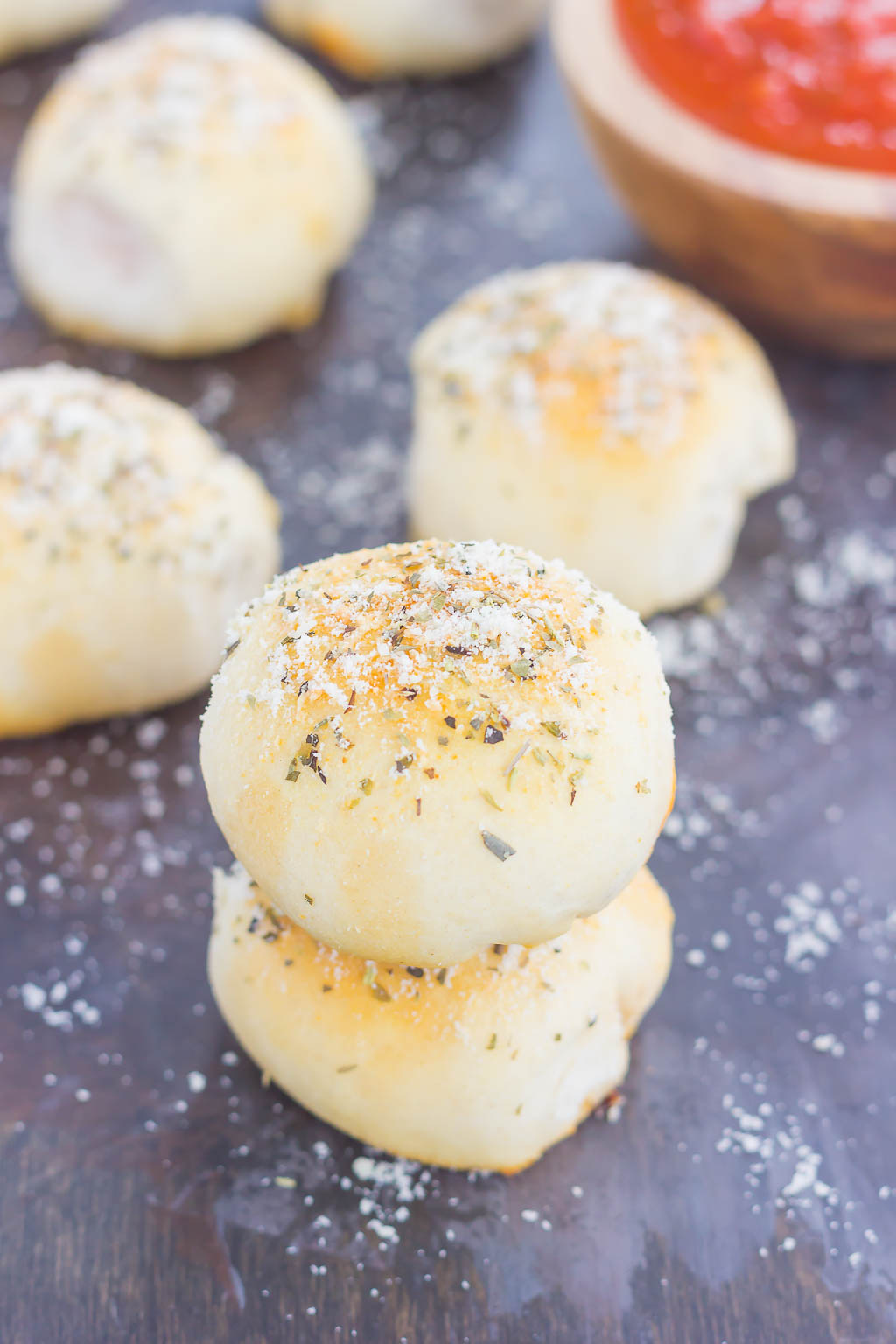 These Stuffed Pizza Rolls taste just like your favorite pizza, combined into a roll and drizzled with a zesty, buttery glaze!