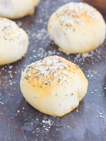 These Stuffed Pizza Rolls taste just like your favorite pizza, combined into a roll and drizzled with a zesty, buttery glaze!