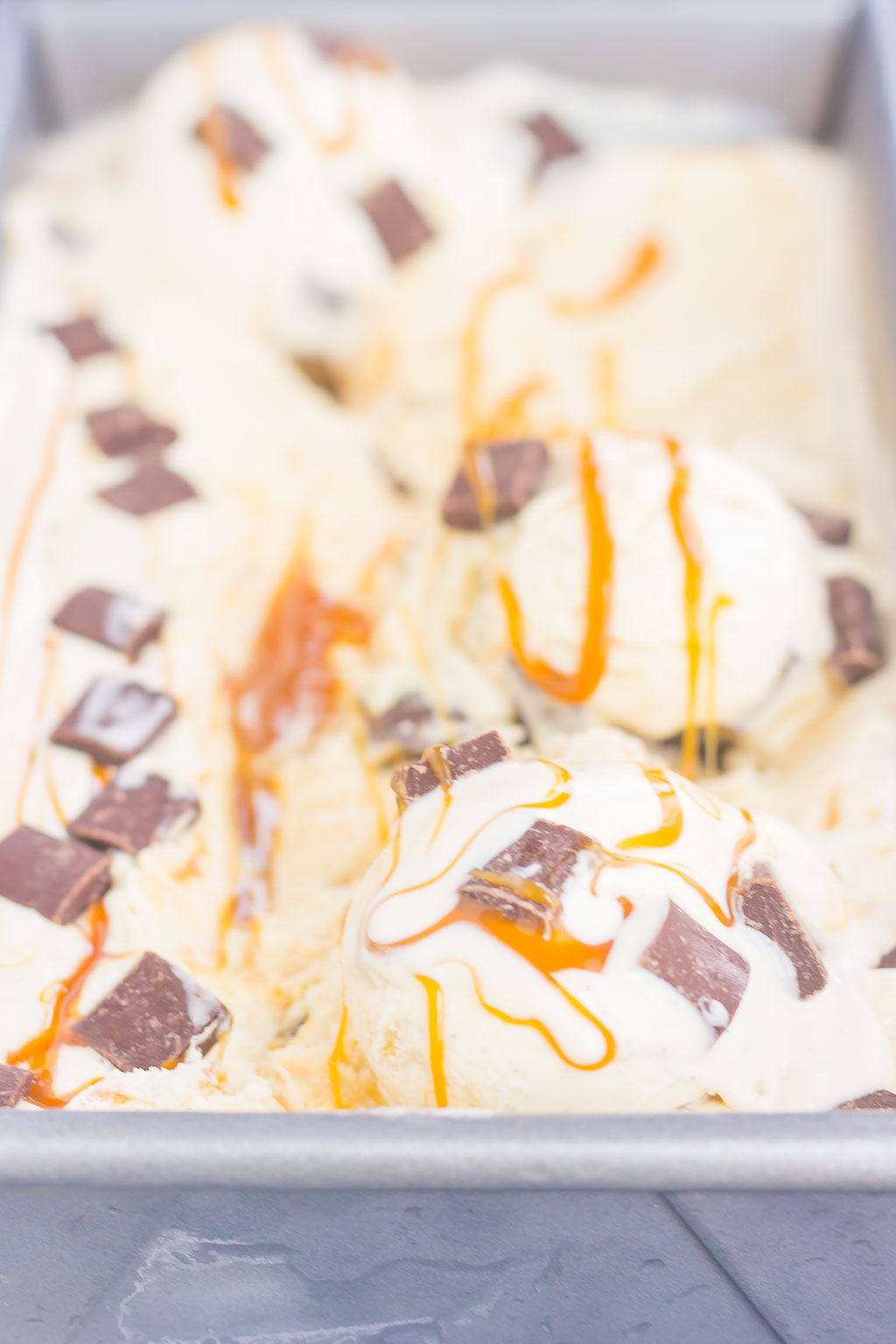 This {No-Churn} Salted Caramel Chocolate Chunk Ice Cream is a simple, must-make treat for the summer. Sweet vanilla ice cream is swirled with rich, salted caramel and loaded with chunks of chocolate. Easy to make and with no ice cream maker needed, you can have this decadent dessert ready in no time!