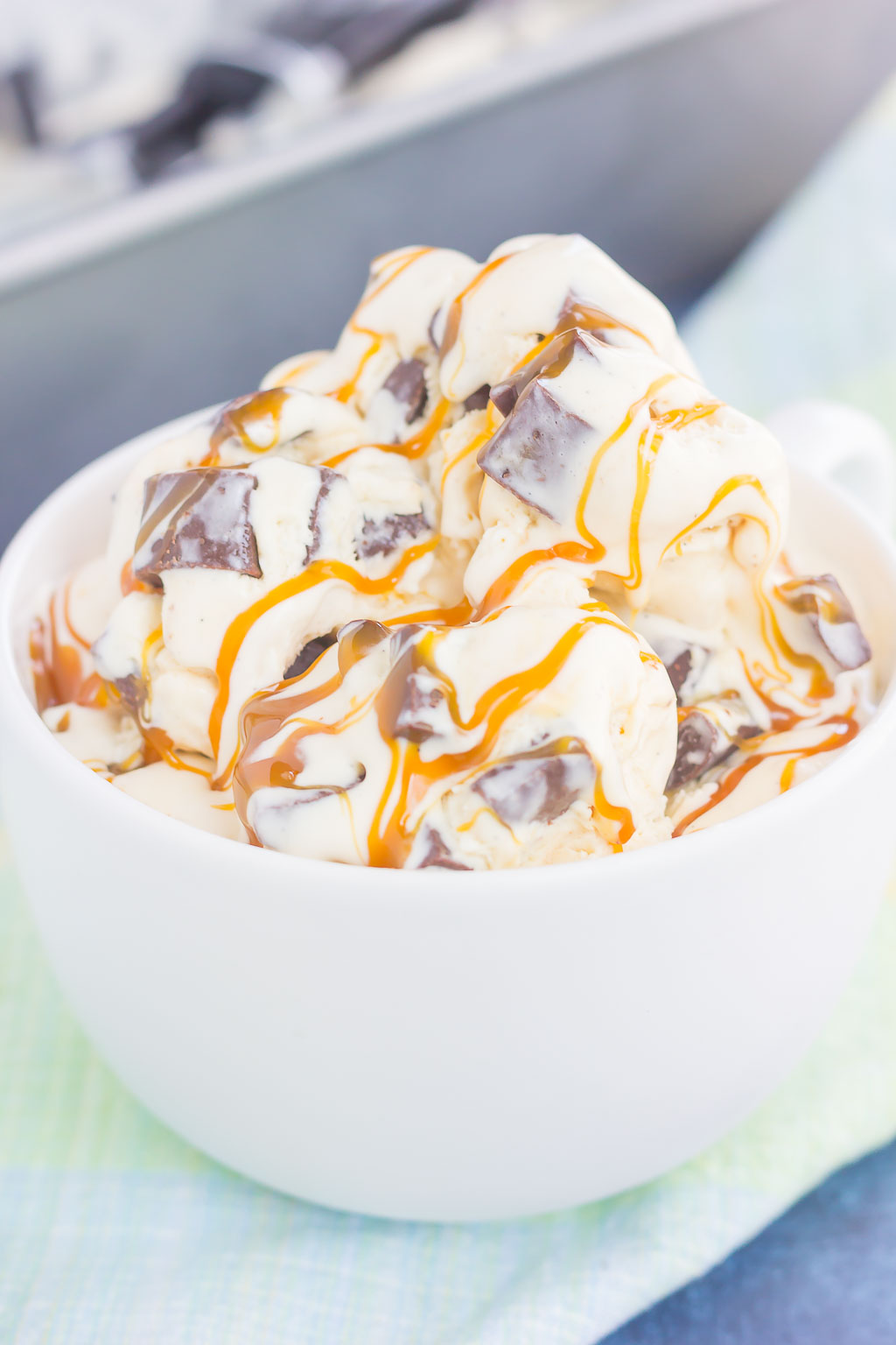 This {No-Churn} Salted Caramel Chocolate Chunk Ice Cream is a simple, must-make treat for the summer. Sweet vanilla ice cream is swirled with rich, salted caramel and loaded with chunks of chocolate. Easy to make and with no ice cream maker needed, you can have this decadent dessert ready in no time!