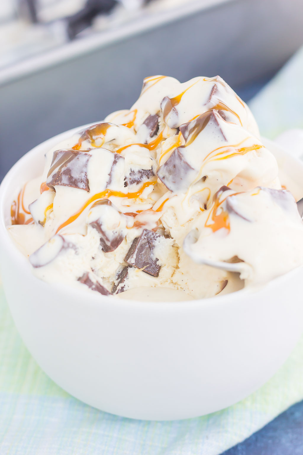 This {No-Churn} Salted Caramel Chocolate Chunk Ice Cream is a simple, must-make treat for the summer. Sweet vanilla ice cream is swirled with rich, salted caramel and loaded with chunks of chocolate. Easy to make and with no ice cream maker needed, you can have this decadent dessert ready in no time!