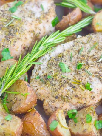 This Sheet Pan Rosemary Herb Pork Chops and Roasted Potatoes is a deliciously easy meal for busy nights. Made entirely on one pan and seasoned to perfection with fresh rosemary and herbs, this simple dish is sure to be a dinnertime favorite all year long!