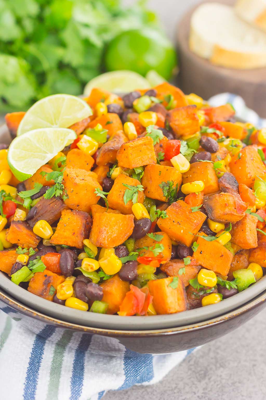 sweet potato potato salad garnished with cilantro and lime wedges 