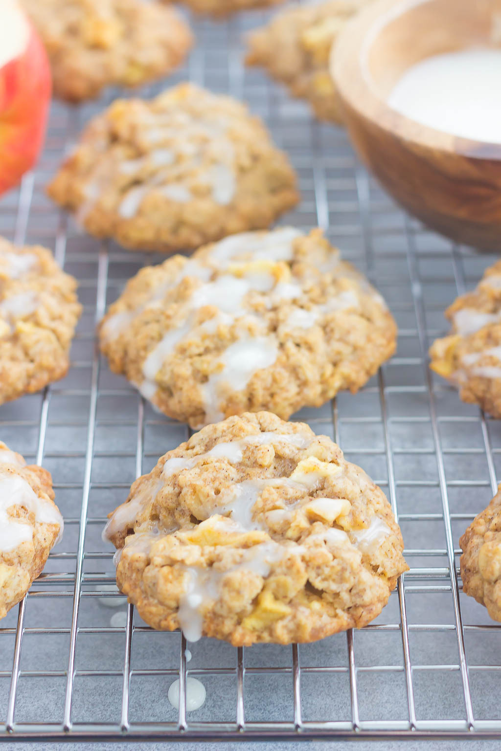 side view of apple cinnamon oatmeal cookies on a wire cooling rack. 