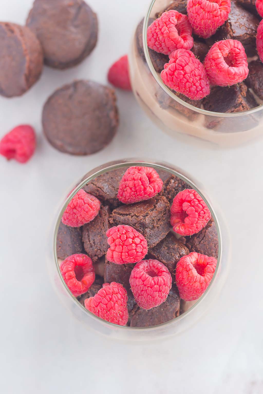 Raspberry Brownie Parfaits make a simple dessert that's ready in no time. Rich brownie chunks and fresh raspberries are layered together with whipped chocolate pudding to create the perfect sweet treat!