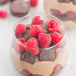 Raspberry Brownie Parfaits make a simple dessert that's ready in no time. Rich brownie chunks and fresh raspberries are layered together with whipped chocolate pudding to create the perfect sweet treat!