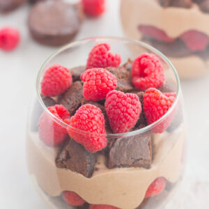 Raspberry Brownie Parfaits make a simple dessert that's ready in no time. Rich brownie chunks and fresh raspberries are layered together with whipped chocolate pudding to create the perfect sweet treat!