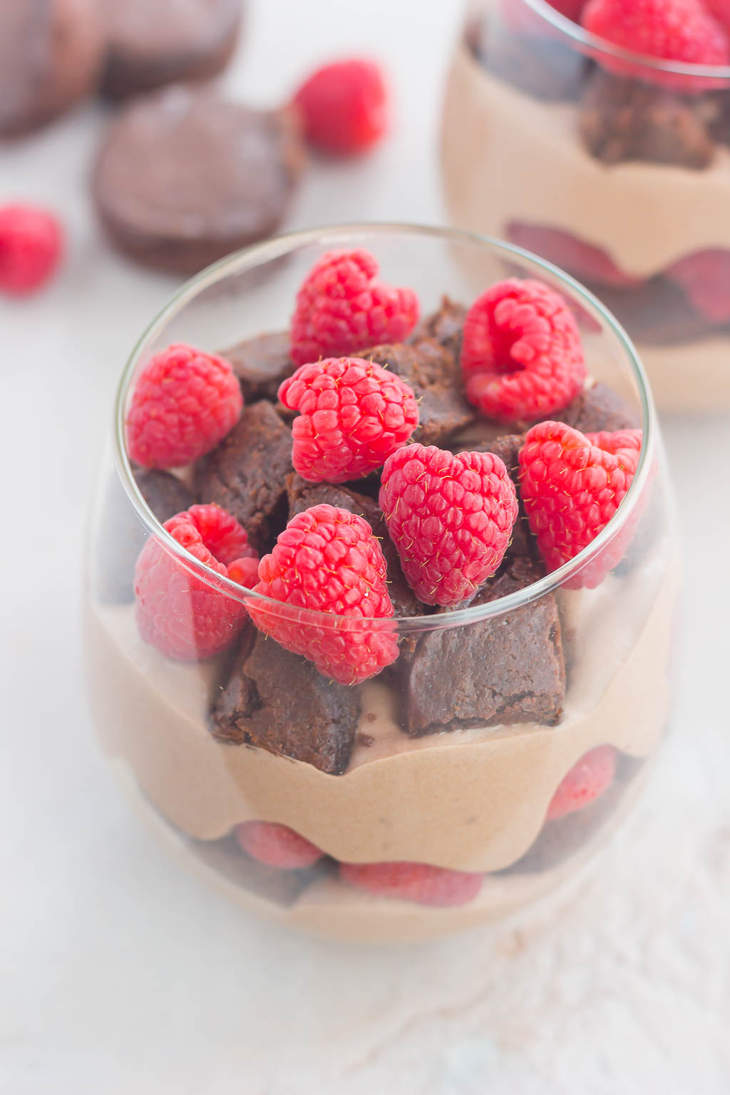 Raspberry Brownie Parfaits make a simple dessert that's ready in no time. Rich brownie chunks and fresh raspberries are layered together with whipped chocolate pudding to create the perfect sweet treat!