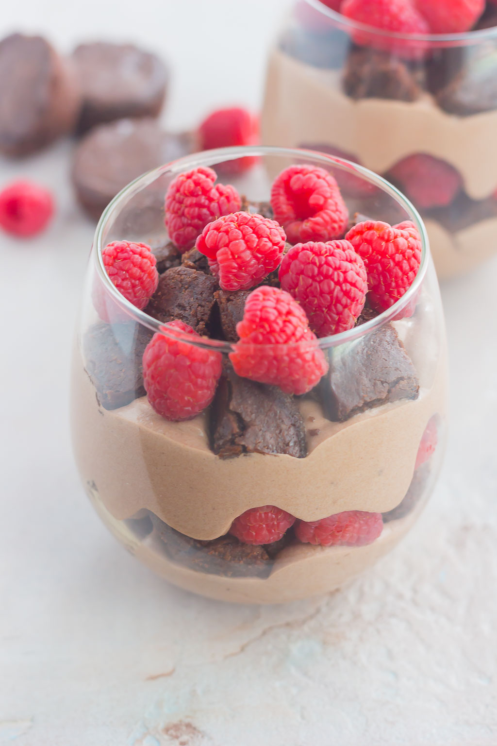 Raspberry Brownie Parfaits make a simple dessert that's ready in no time. Rich brownie chunks and fresh raspberries are layered together with whipped chocolate pudding to create the perfect sweet treat!