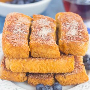 Baked Cinnamon Sugar French Toast Sticks make an easy breakfast that's loaded with flavor. Simple to prepare and baked in the oven, you can have these sticks ready to serve in no time, with a side of syrup for dunking!