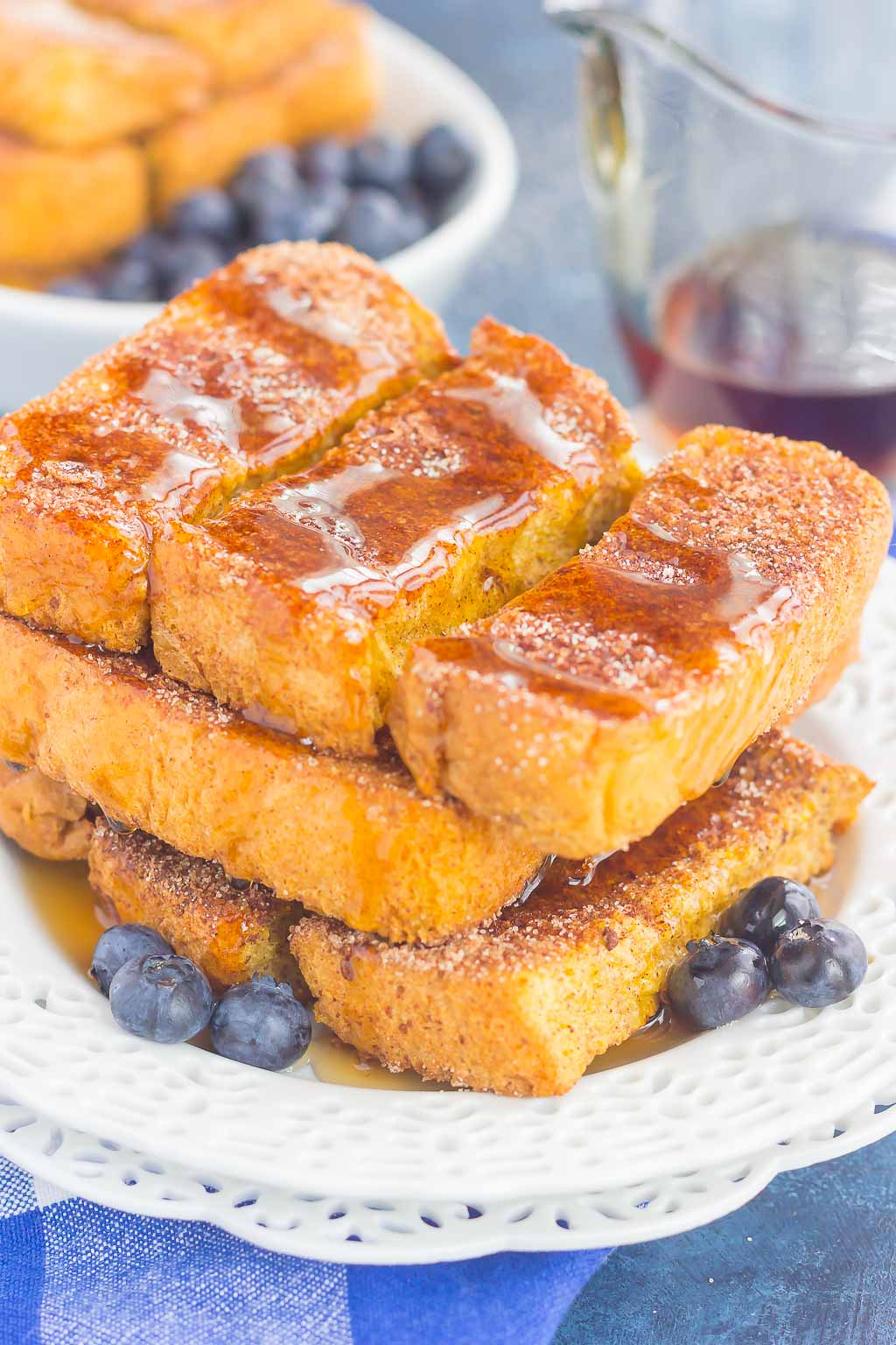 pile of homemade french toast sticks on white plate