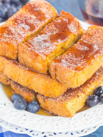 Baked Cinnamon Sugar French Toast Sticks make an easy breakfast that's loaded with flavor. Simple to prepare and baked in the oven, you can have these sticks ready to serve in no time, with a side of syrup for dunking!