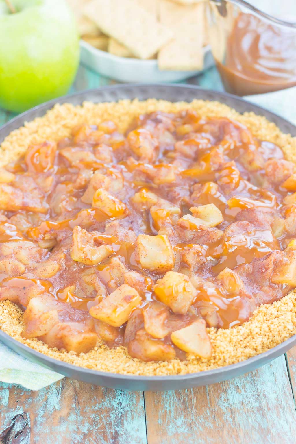 This Easy Caramel Apple Pie Dip tastes just like the classic pie, but without all of the prep work. Fresh apples are tossed with spices and then sautéed until tender. Drizzled with caramel and loaded onto a buttery graham cracker crust, this simple dessert is loaded with fall flavors!