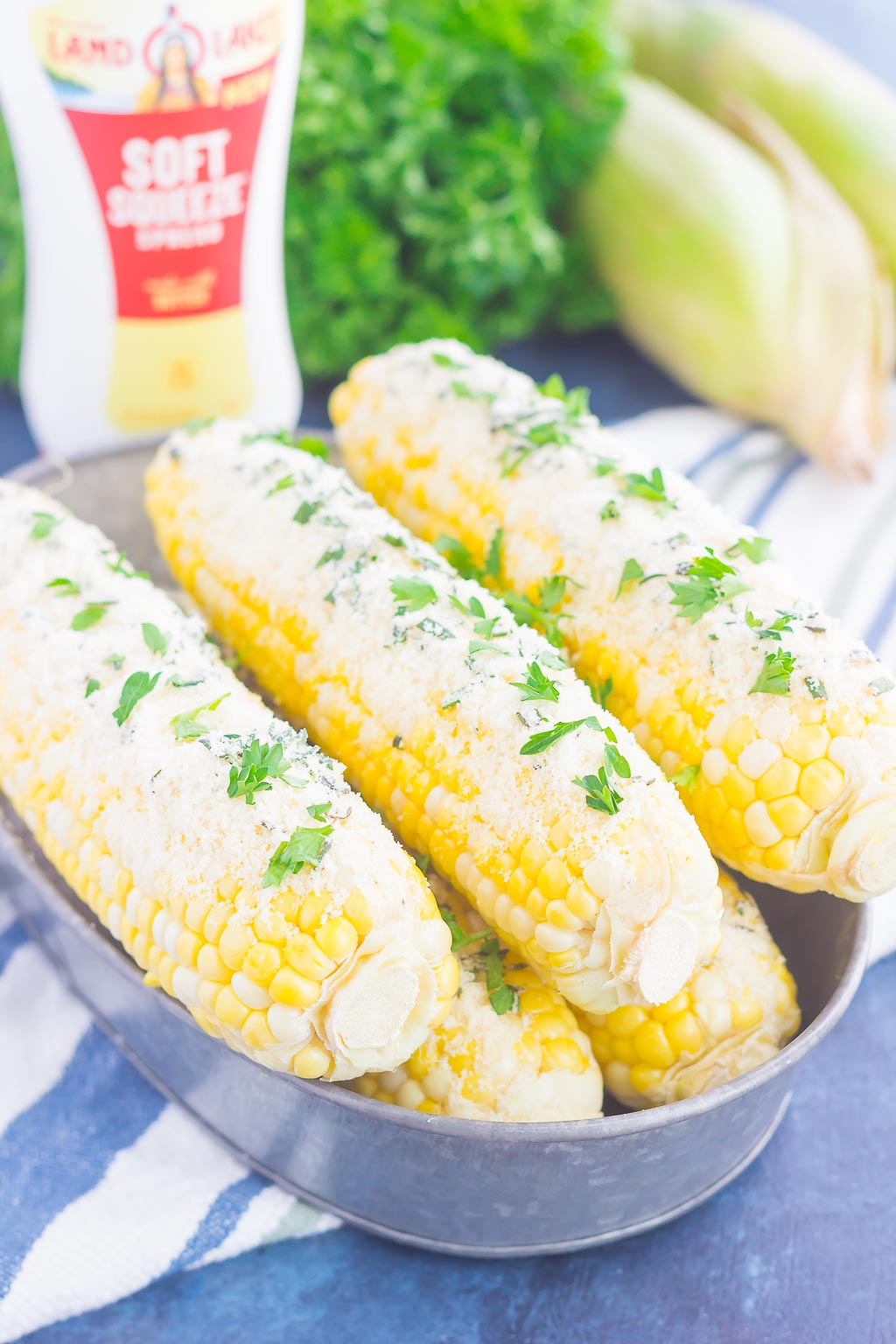 This Parmesan Herb Corn on the Cob is an easy side dish that's loaded with flavor. A buttery spread of Parmesan, garlic and herbs top fresh corn that's roasted to perfection! #corn #cornonthecob #parmesan #parmesancorn #cornrecipe #cornonthecobrecipe #sidedish #easysidedish