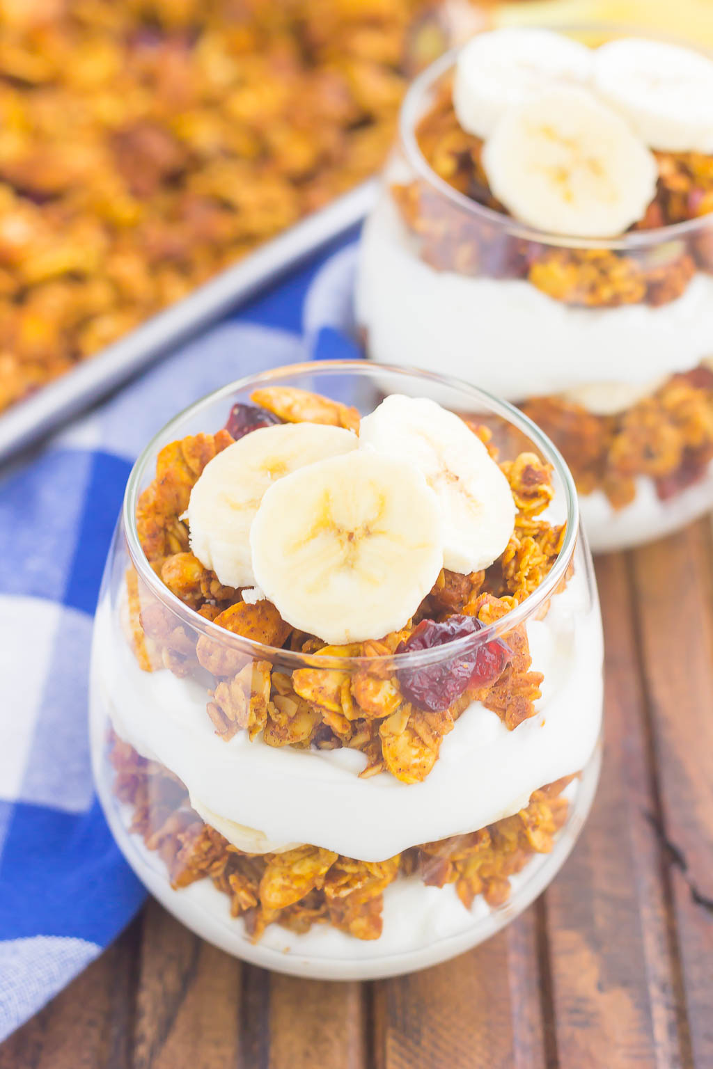 Pumpkin Banana Yogurt Parfait makes a deliciously simple breakfast or snack. Packed with vanilla yogurt, pumpkin spice granola and fresh banana slices, this healthier dish is easy to make and perfect for fall! #parfait #yogurtparfait #pumpkinparfait #pumpkinyogurt #pumpkinbreakfast #pumpkinsnack #breakfast #snack #healthybreakfast