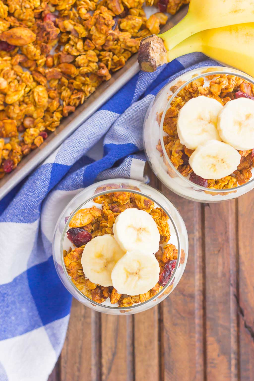 Pumpkin Banana Yogurt Parfait makes a deliciously simple breakfast or snack. Packed with vanilla yogurt, pumpkin spice granola and fresh banana slices, this healthier dish is easy to make and perfect for fall!