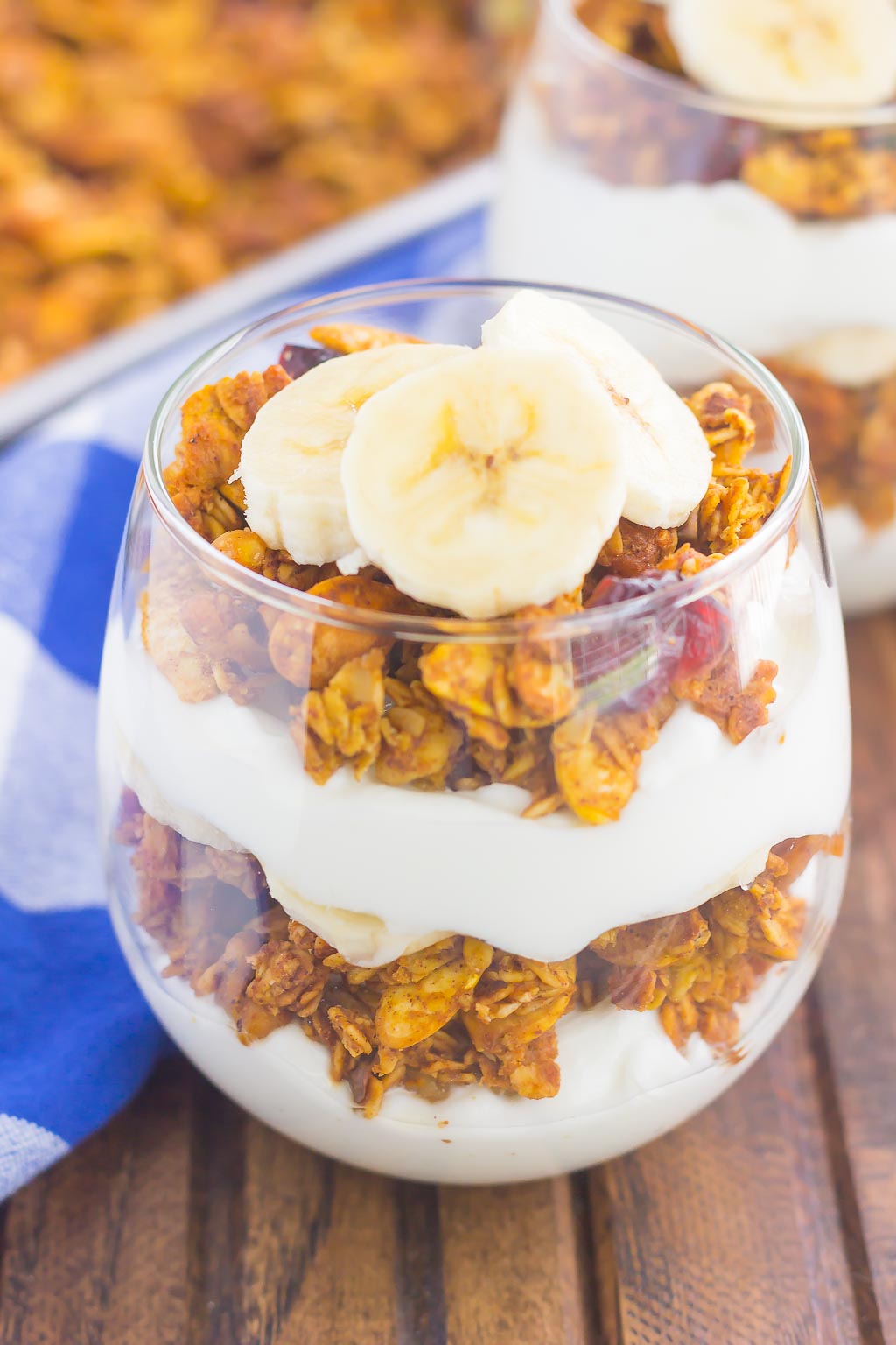 Pumpkin Banana Yogurt Parfait makes a deliciously simple breakfast or snack. Packed with vanilla yogurt, pumpkin spice granola and fresh banana slices, this healthier dish is easy to make and perfect for fall!