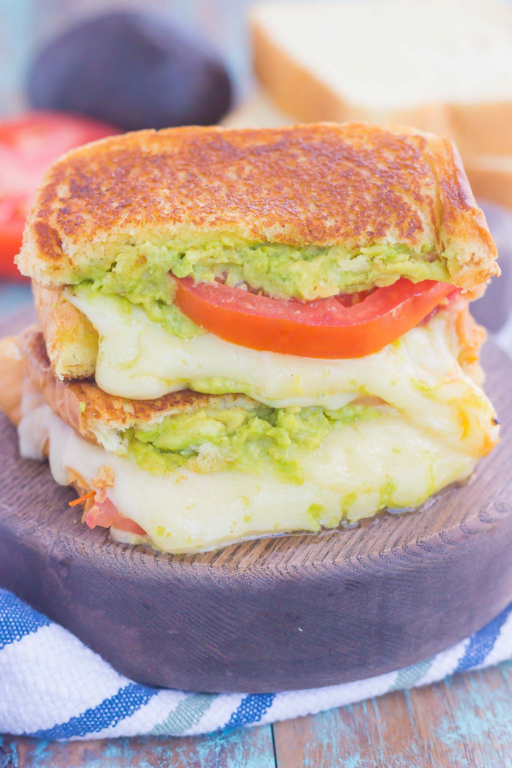 Tomato, Avocado and Mozzarella Grilled Cheese is filled with fresh tomato slices, smashed avocado and creamy mozzarella cheese. Grilled until golden on the outside and melty on the inside, this sandwich is perfect to pair with soup for an easy lunch or dinner!