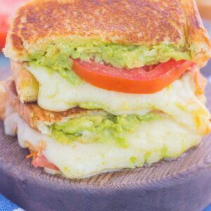 Tomato, Avocado and Mozzarella Grilled Cheese is filled with fresh tomato slices, smashed avocado and creamy mozzarella cheese. Grilled until golden on the outside and melty on the inside, this sandwich is perfect to pair with soup for an easy lunch or dinner!