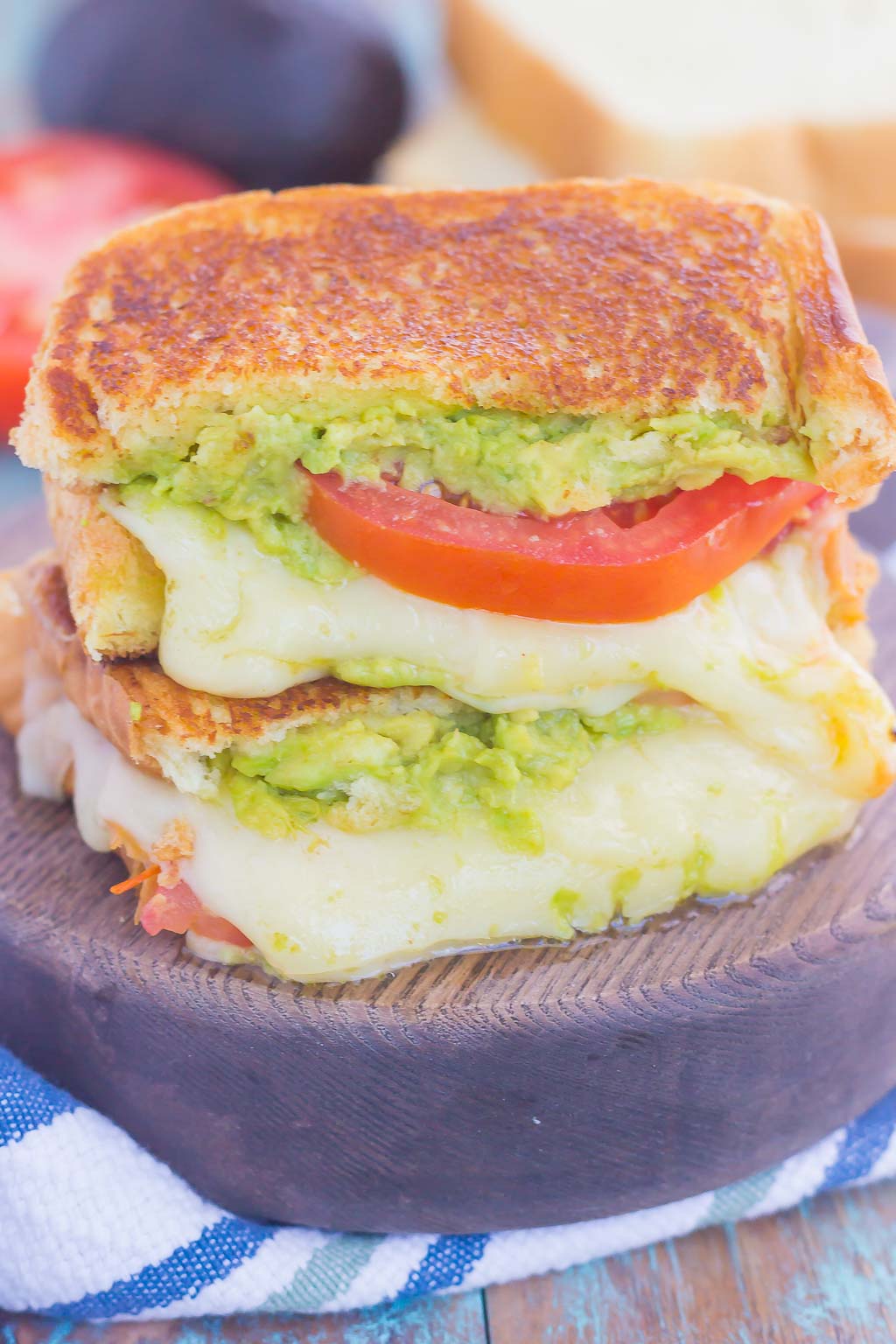 Tomato, Avocado and Mozzarella Grilled Cheese is filled with fresh tomato slices, smashed avocado and creamy mozzarella cheese. Grilled until golden on the outside and melty on the inside, this sandwich is perfect to pair with soup for an easy lunch or dinner!