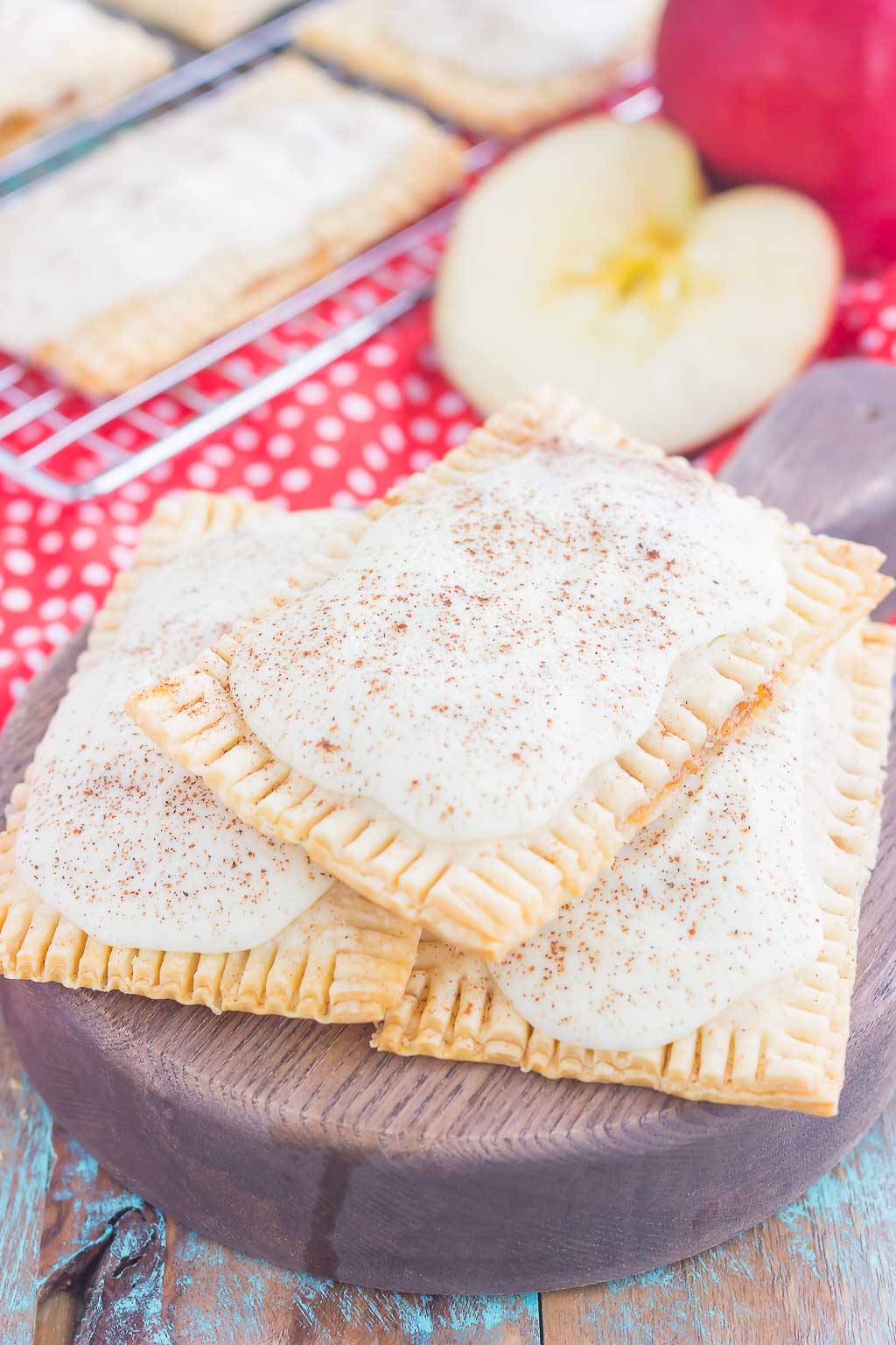 These Apple Pie Pop Tarts are an easy treat that's perfect for breakfast or dessert. Flaky pie crust surrounds sweet apple pie filling and is frosted with white chocolate and apple pie spice. Simple to make and better than the store-bought kind, you'll love the cozy taste of these homemade pop tarts!