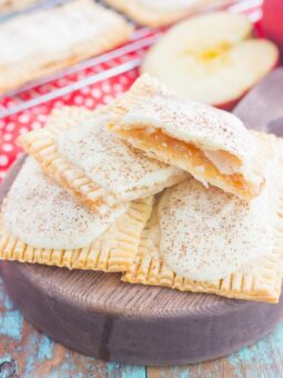 These Apple Pie Pop Tarts are an easy treat that's perfect for breakfast or dessert. Flaky pie crust surrounds sweet apple pie filling and is frosted with white chocolate and apple pie spice. Simple to make and better than the store-bought kind, you'll love the cozy taste of these homemade pop tarts!