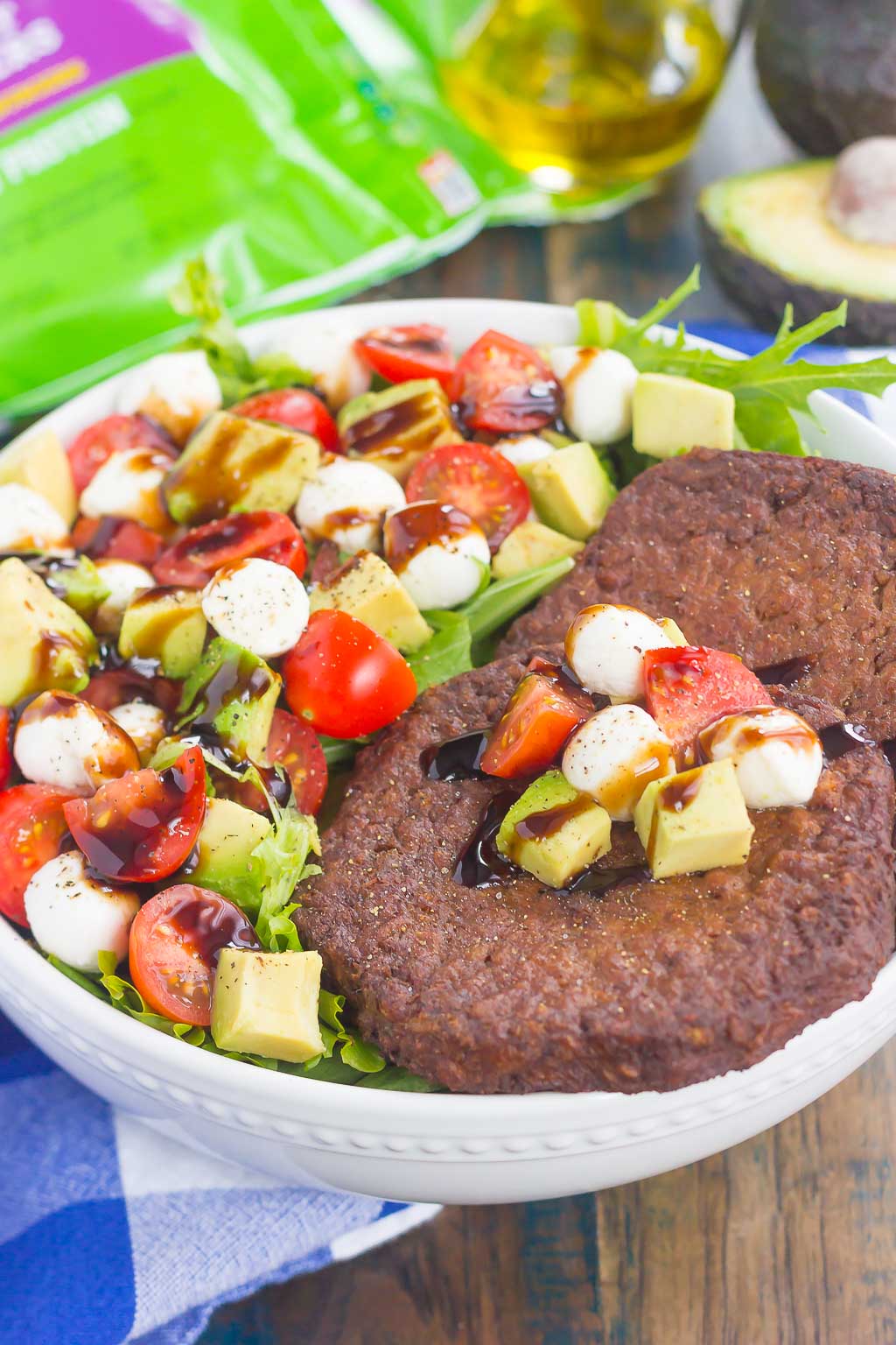 This Avocado Caprese Burger Salad is a healthier way to switch up your meal routine. It's packed with diced avocado, cherry tomatoes, mozzarella pearls, veggie burgers and drizzled with a sweet balsamic glaze. Simple to make and perfect for just about any time, you'll love the delicious taste of this flavorful salad!