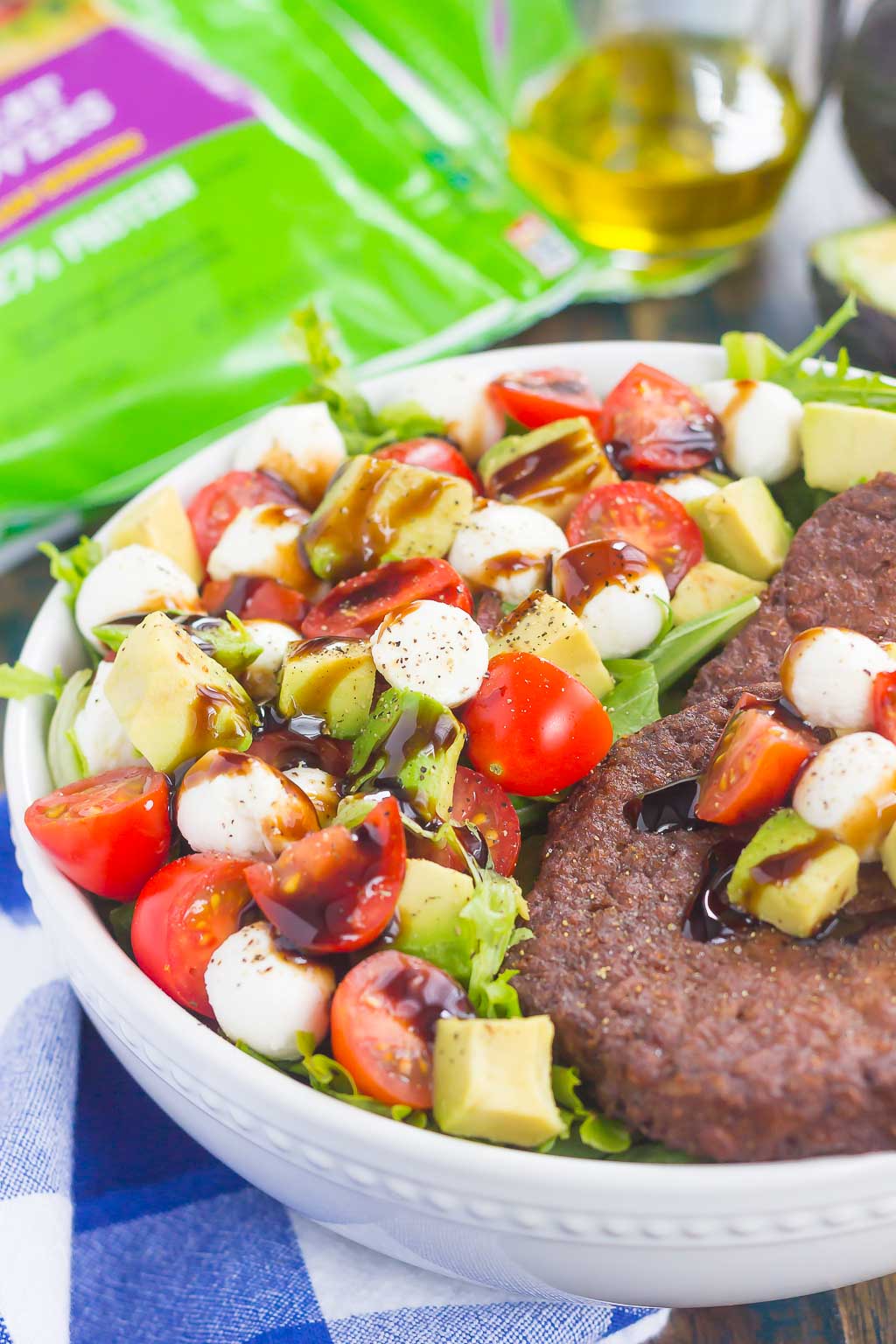 This Avocado Caprese Burger Salad is a healthier way to switch up your meal routine. It's packed with diced avocado, cherry tomatoes, mozzarella pearls, veggie burgers and drizzled with a sweet balsamic glaze. Simple to make and perfect for just about any time, you'll love the delicious taste of this flavorful salad!