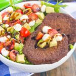 This Avocado Caprese Burger Salad is a healthier way to switch up your meal routine. It's packed with diced avocado, cherry tomatoes, mozzarella pearls, veggie burgers and drizzled with a sweet balsamic glaze. Simple to make and perfect for just about any time, you'll love the delicious taste of this flavorful salad!