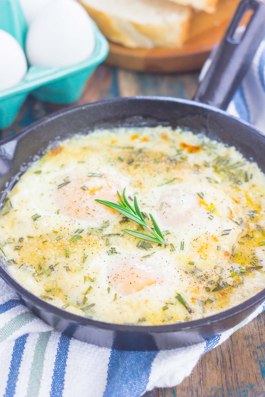 Oven Baked Eggs with Rosemary and Thyme make a simple breakfast that's loaded with flavor. Fresh herbs and a sprinkling of cheese give this dish a savory blend that's perfect for a cozy dish. Serve with a side of crusty bread and this will quickly become a new favorite!