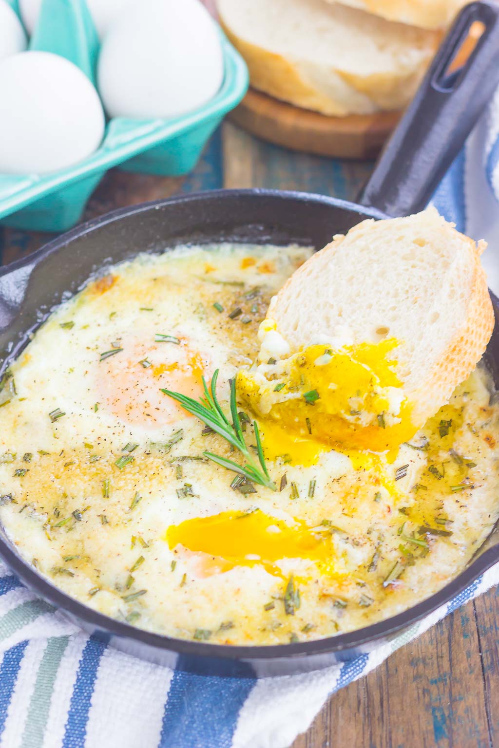 Baked Eggs with Rosemary and Thyme make a simple breakfast that's loaded with flavor. Fresh herbs and a sprinkling of cheese give this dish a savory blend that's perfect for a cozy dish. Serve with a side of crusty bread and this will quickly become a new favorite!