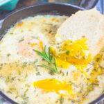 Baked Eggs with Rosemary and Thyme make a simple breakfast that's loaded with flavor. Fresh herbs and a sprinkling of cheese give this dish a savory blend that's perfect for a cozy dish. Serve with a side of crusty bread and this will quickly become a new favorite!