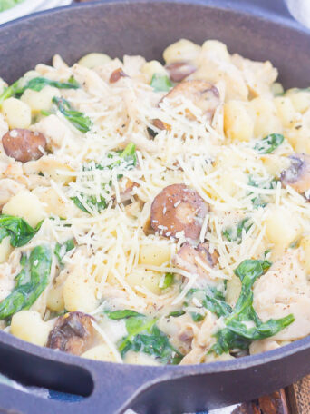 This One Pan Chicken and Spinach Gnocchi is perfect for an easy weeknight meal. Tender gnocchi is paired with shredded chicken, mushrooms and fresh spinach, and then tossed in a light parmesan cream sauce. Simple to make and full of flavor, this comforting dish will be a favorite all year long!