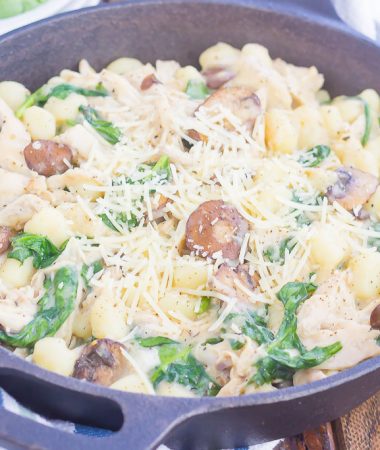 This One Pan Chicken and Spinach Gnocchi is perfect for an easy weeknight meal. Tender gnocchi is paired with shredded chicken, mushrooms and fresh spinach, and then tossed in a light parmesan cream sauce. Simple to make and full of flavor, this comforting dish will be a favorite all year long!