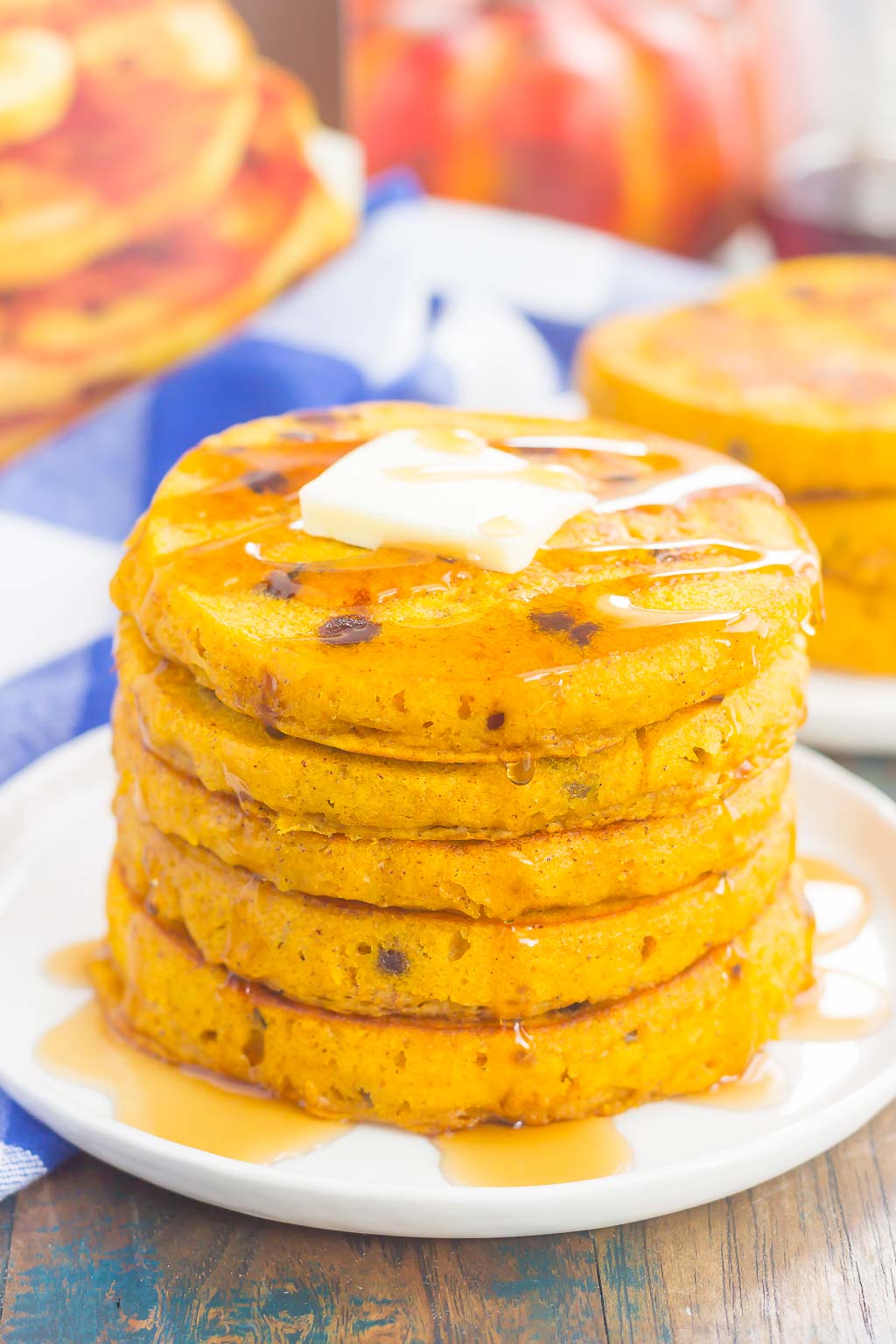 These Pumpkin Chocolate Chip Pancakes make a deliciously cozy breakfast for fall. Filled with sweet pumpkin and bursting with chocolate chips, these simple pancakes are soft, fluffy and so easy to make!  #pancakes #pumpkinpancakes #chocolatechippancakes #pancakerecipe #breakfast