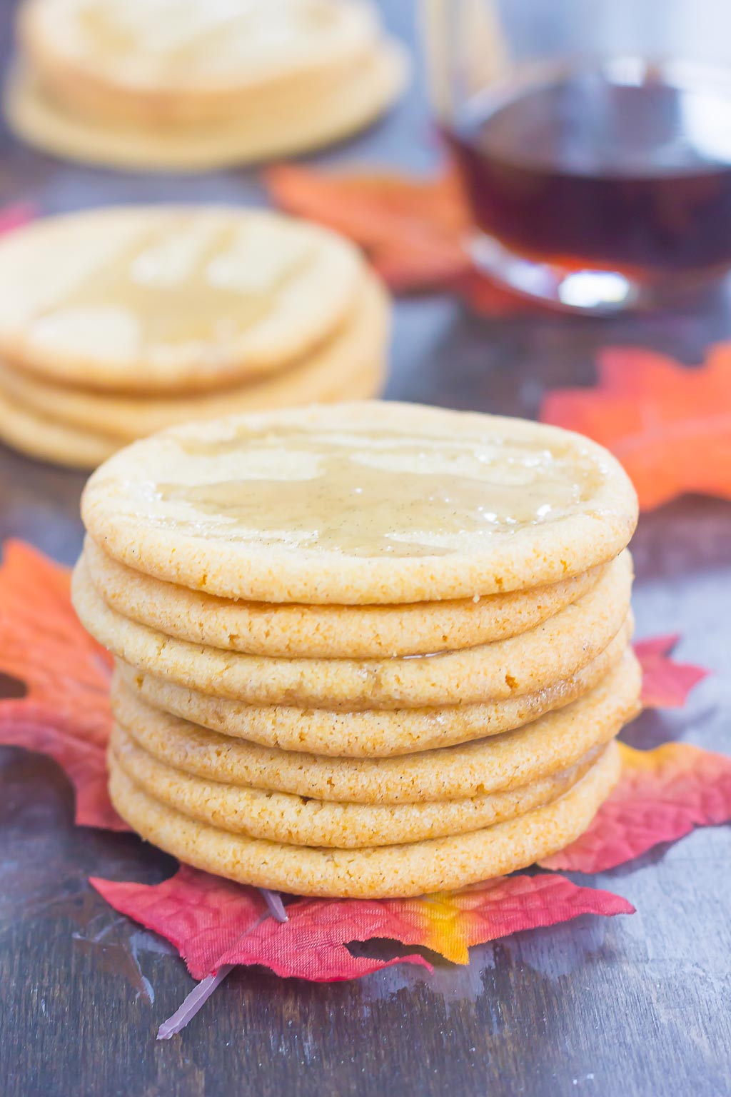 A stack of maple sugar cookies topped with maple glaze. 