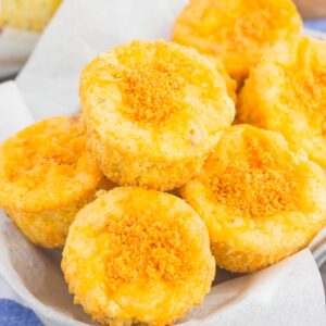 These Cheesy Cornbread Muffins are loaded with flavor and easy to make. Filled with cheddar cheese, zesty spices and baked until golden, these muffins are perfect to serve as a simple side dish or snack!