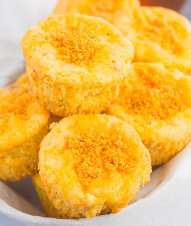 These Cheesy Cornbread Muffins are loaded with flavor and easy to make. Filled with cheddar cheese, zesty spices and baked until golden, these muffins are perfect to serve as a simple side dish or snack!