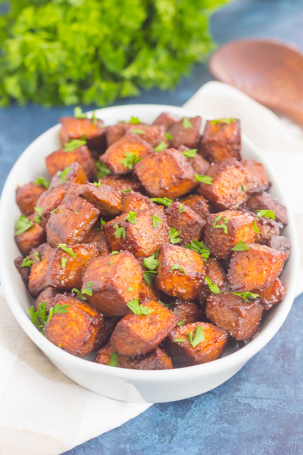 dish of roasted sweet potato cubes garnished with parsley 