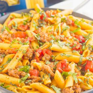 This Tomato Basil Pasta with Italian Sausage is an easy, one pan meal that's perfect for busy weeknights. Filled with tender pasta, Italian sausage, and tossed in a simple tomato basil sauce, this dish is ready in less than 30 minutes and will become a new dinnertime favorite!