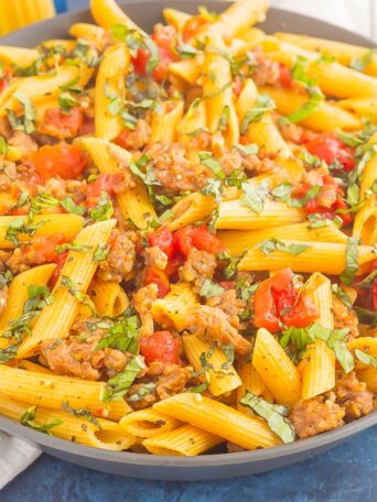 This Tomato Basil Pasta with Italian Sausage is an easy, one pan meal that's perfect for busy weeknights. Filled with tender pasta, Italian sausage, and tossed in a simple tomato basil sauce, this dish is ready in less than 30 minutes and will become a new dinnertime favorite!