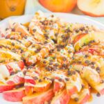 These Caramel Apple Nachos make a deliciously easy snack that's perfect for just about any time. Apple slices are drizzled with a rich caramel sauce and white chocolate, and then topped with toffee bits, chocolate chips, and sprinkles. This simple treat is ready in less than 10 minutes and is sure to be a crowd-pleaser!