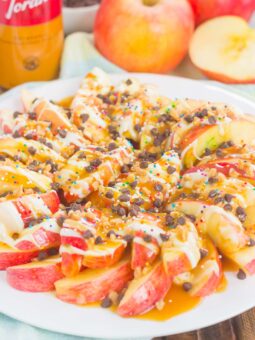 These Caramel Apple Nachos make a deliciously easy snack that's perfect for just about any time. Apple slices are drizzled with a rich caramel sauce and white chocolate, and then topped with toffee bits, chocolate chips, and sprinkles. This simple treat is ready in less than 10 minutes and is sure to be a crowd-pleaser!