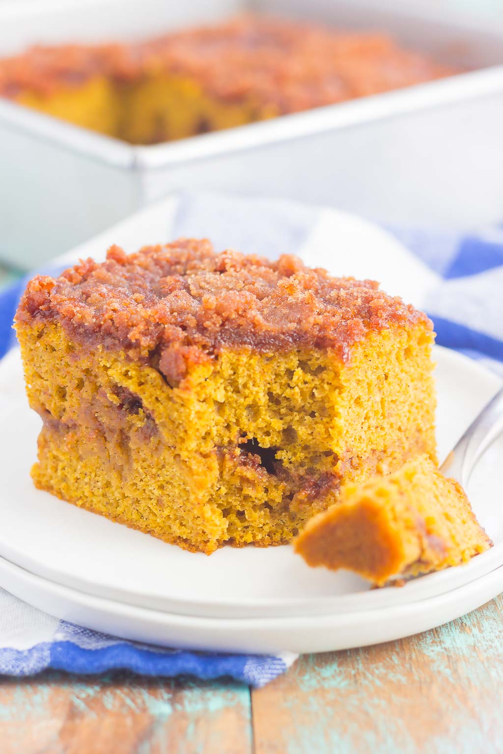 This Gluten Free Pumpkin Cinnamon Crumb Cake requires just a few ingredients and is ready in no time. Fluffy pumpkin cake is swirled with a sweet cinnamon streusel and then baked until golden. This easy cake is perfect to serve at all of your holiday gatherings! #cake #pumpkincake #crumbcake #glutenfree #glutenfreecake #glutenfreepumpkincake #pumpkincrumbcake #pumpkinrecipes #pumpkindessert #dessert