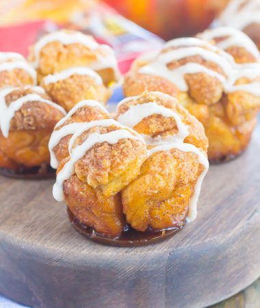 These Pumpkin Spice Monkey Bread Muffins are a simple treat that's perfect for breakfast or dessert. Pre-made dough is rolled in a cozy pumpkin spice blend and then baked in muffin cups. Topped with a sweet pumpkin glaze and great for the holidays, this gooey muffin is sure to impress everyone!