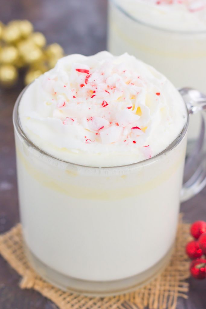 a mug of white hot chocolate with peppermint candies on top