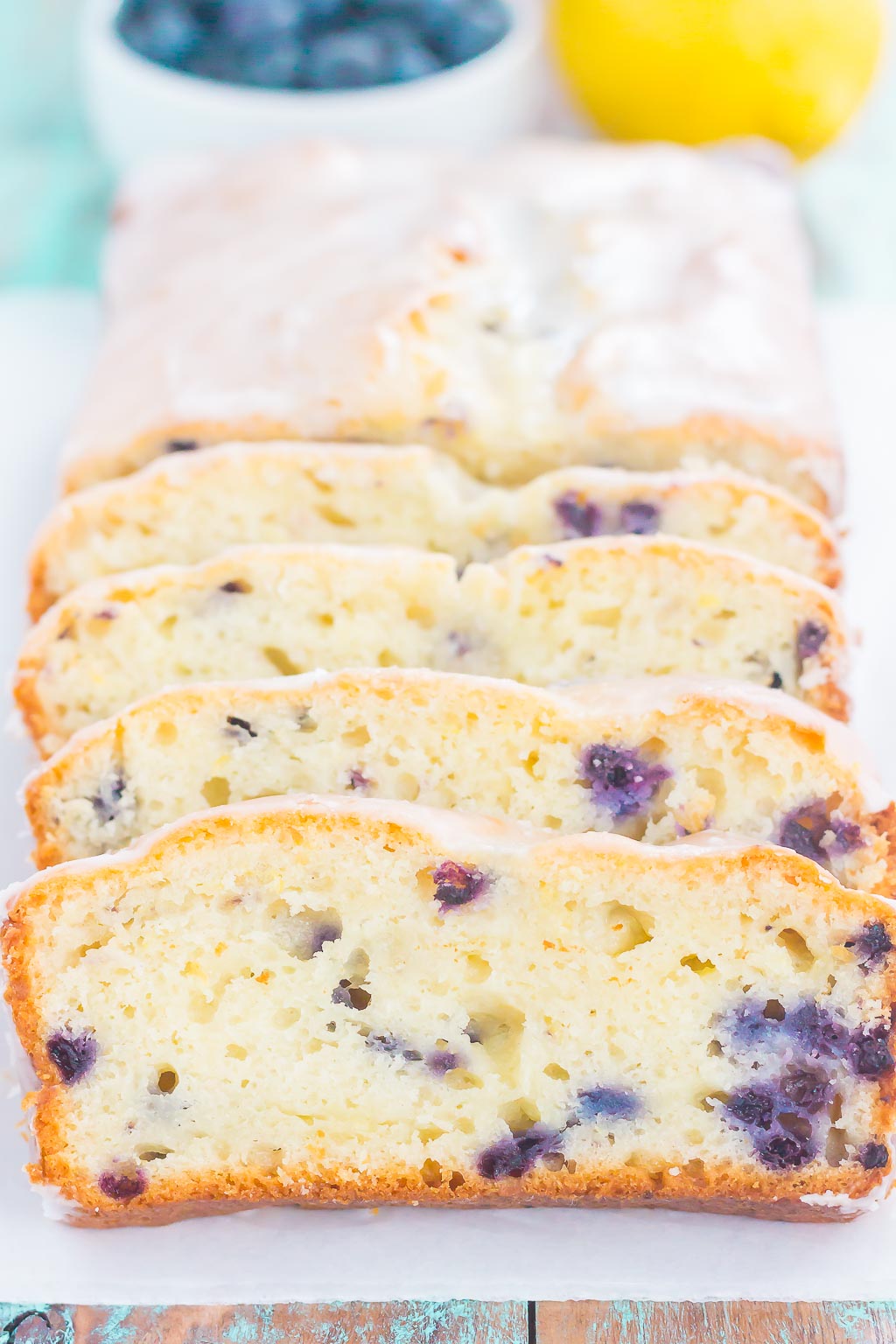 This Lemon Blueberry Bread is perfectly sweet, moist, and simple to make. An easy lemon glaze adds a touch of sweetness that makes this bread perfect for breakfast or dessert! #bread #lemonbread #blueberrybread #lemonblueberrybread #quickbread #dessert 