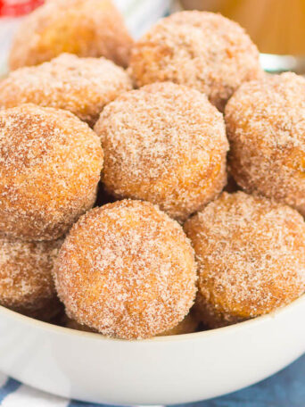 These Baked Cinnamon Sugar Donut Holes are soft, fluffy, and easy to make. Sweet cinnamon and sugar gives this simple baked donut the perfect touch of flavor. Perfect to serve for breakfast or dessert!