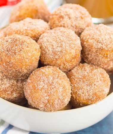 These Baked Cinnamon Sugar Donut Holes are soft, fluffy, and easy to make. Sweet cinnamon and sugar gives this simple baked donut the perfect touch of flavor. Perfect to serve for breakfast or dessert!