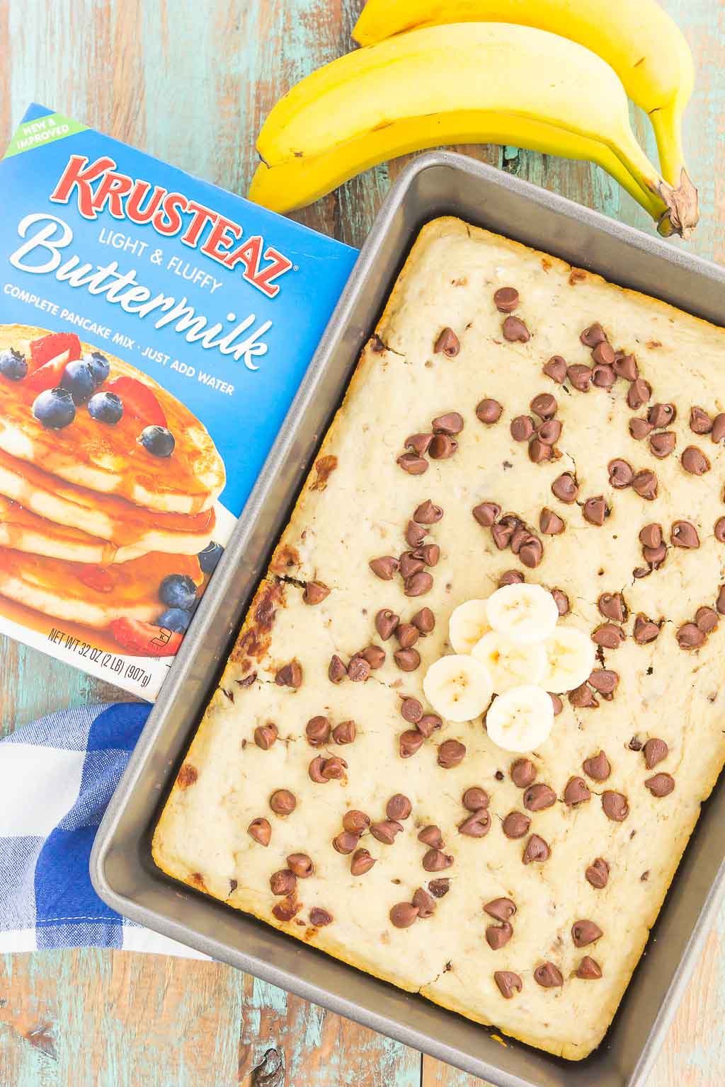 overhead view of sheet pan banana chocolate chip pancakes next to box of pancake mix